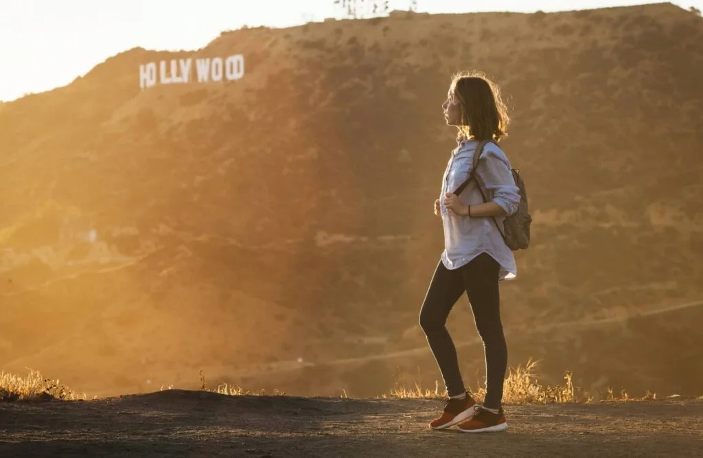 Tourist hiking at Hollywood Hills near world famous landmark Hollywood Sign in Los Angeles, California.