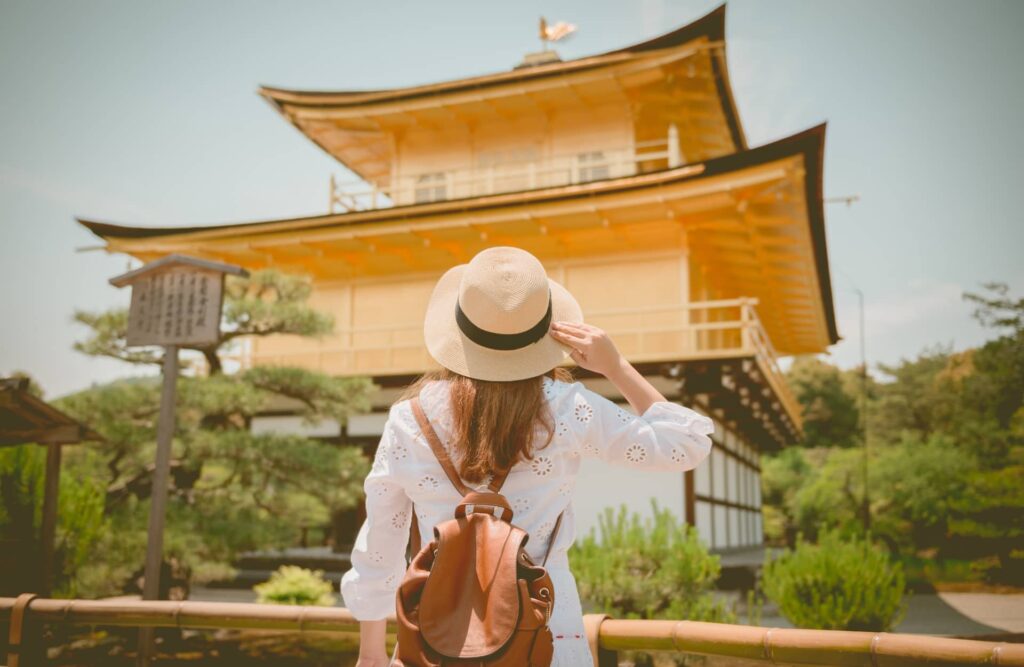 Tourist is watching Kinkaku-ji temple in Kyoto, Japan
