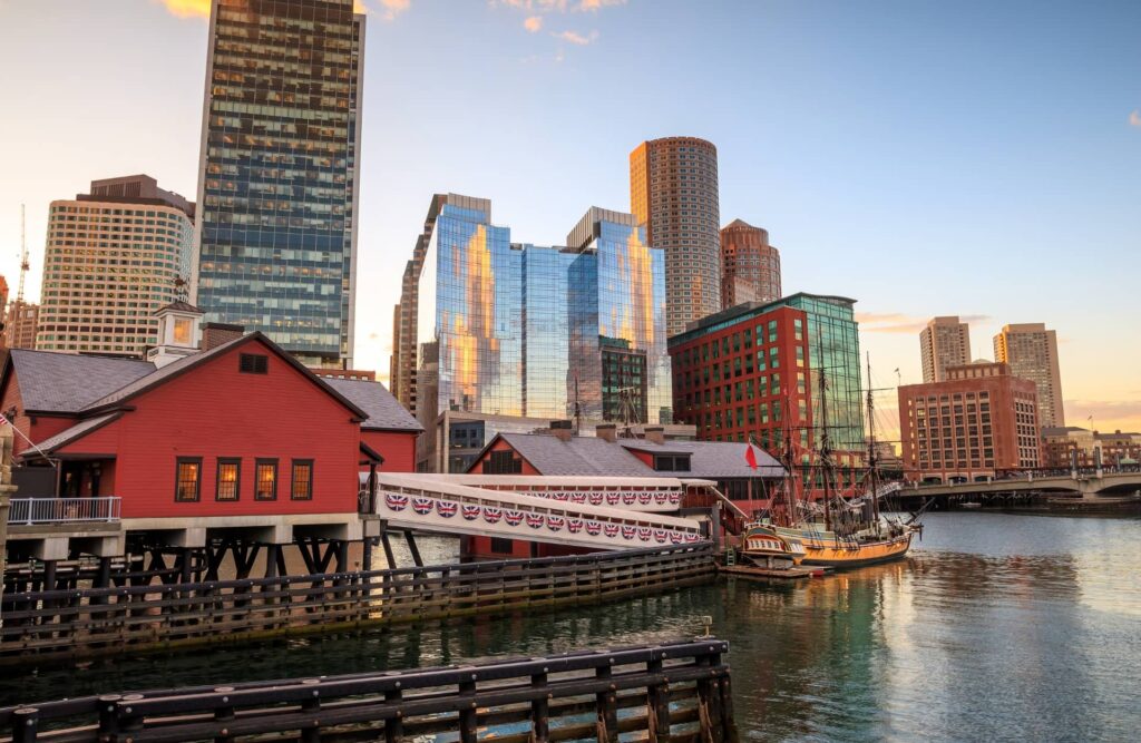 Boston Harbor and Financial District at sunset and Tea Party Ships & Museum in Boston, Massachusetts.